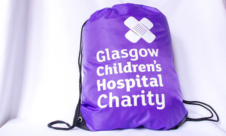 Purple drawstring bag with white Glasgow Children's Hospital Charity logo on the front