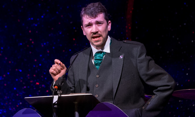 Mr Roddy O'Kane delivering a speech in front of a lectern