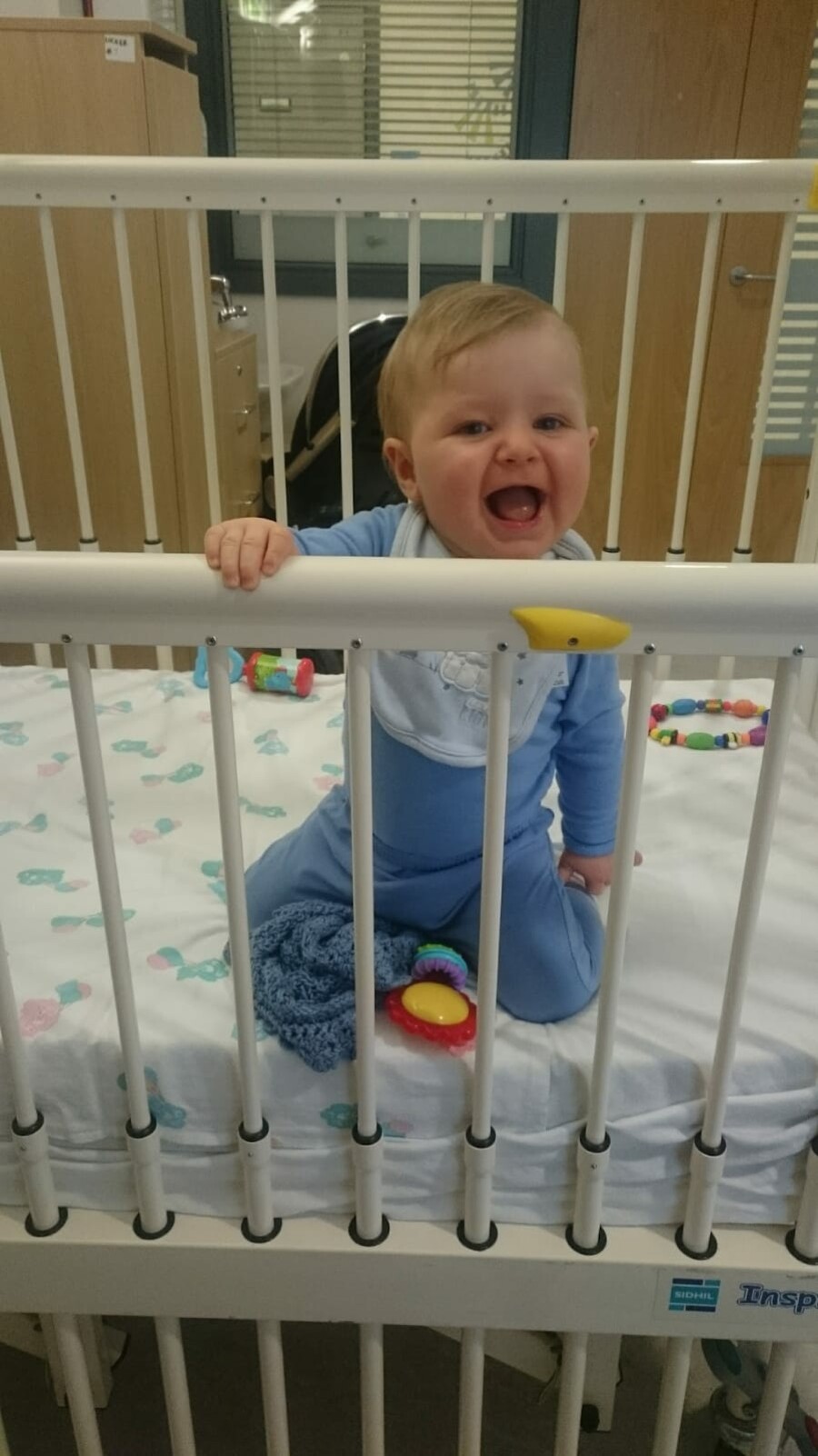 Daniel laughing in his cot