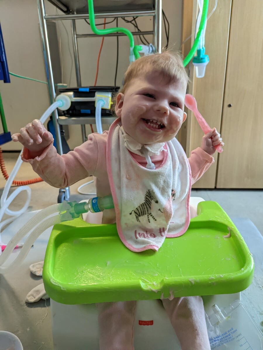 Kaelah smiling and eating her food on the ward